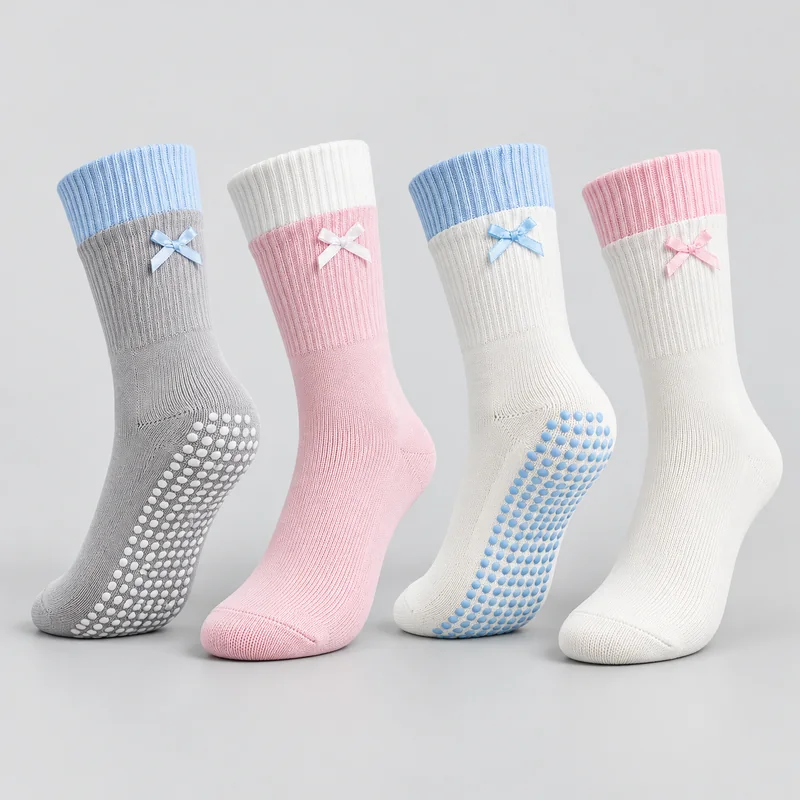 Grey and blue, pink and white, white and blue, and white and pink crew socks with small ribbon bows, ribbed cuffs and round-dot sole grip shown in upper and sole views