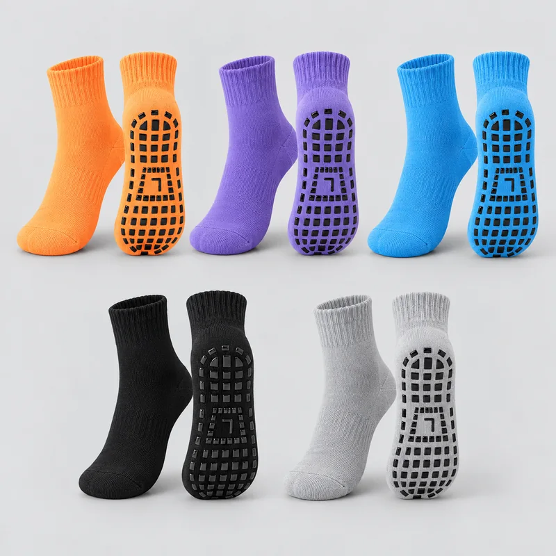 Orange, purple, blue, black and grey crew trampoline socks with ribbed cuffs, displayed in upper and sole views with black rectangular grip pads