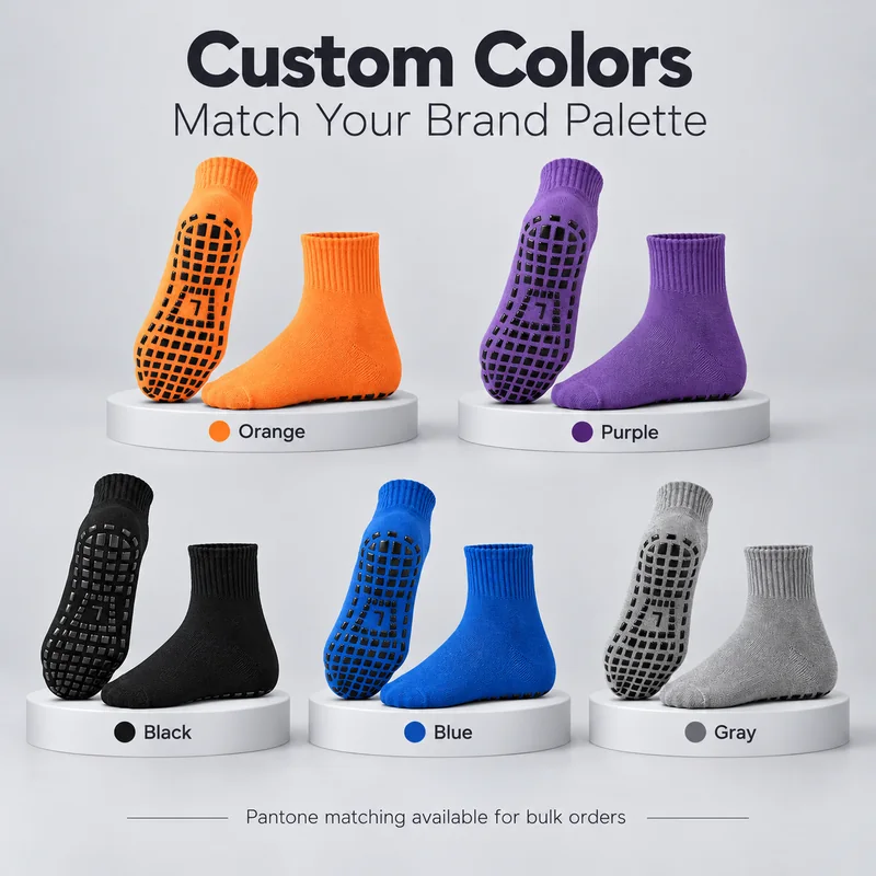 Five crew trampoline sock colour references on display plinths, showing plain-colour bodies, ribbed cuffs and black sole grip pads