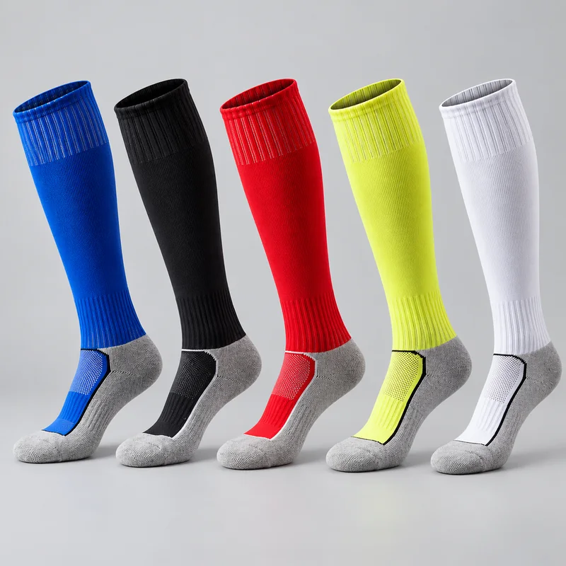 Five knee-high team socks in blue, black, red, fluorescent yellow and white with grey heel, toe and footbed panels