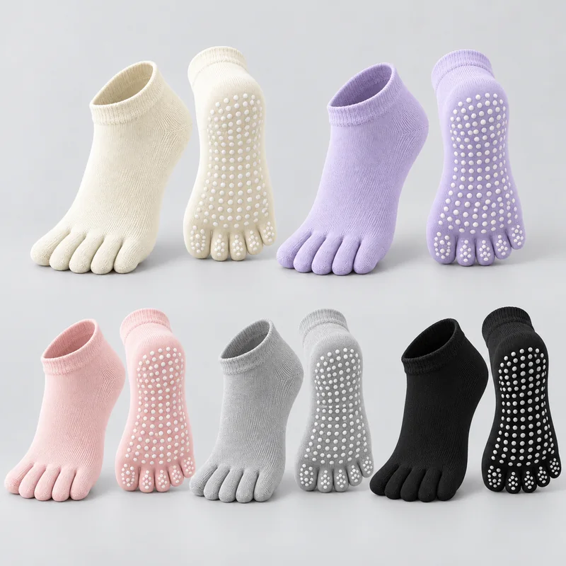 Ivory, lavender, pink, grey and black low-cut five-toe yoga socks shown in upper and sole views with white round grip dots under the sole and individual toes