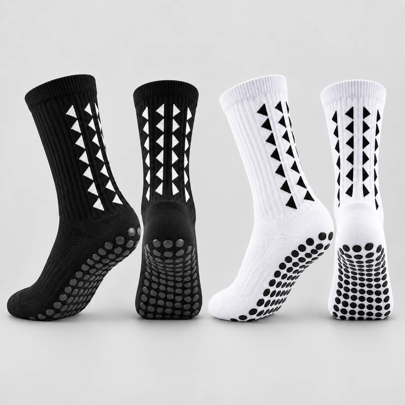 Black and white crew football grip socks with contrasting triangle knit motifs and round sole grip pads
