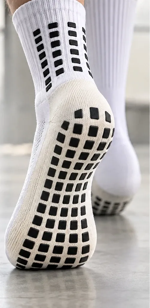 Close product view of a grip sock sole with a black rectangular grip pattern